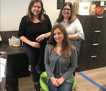 Three females in an office setting