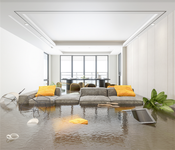 a flooded apartment with water on the floor and furniture floating around