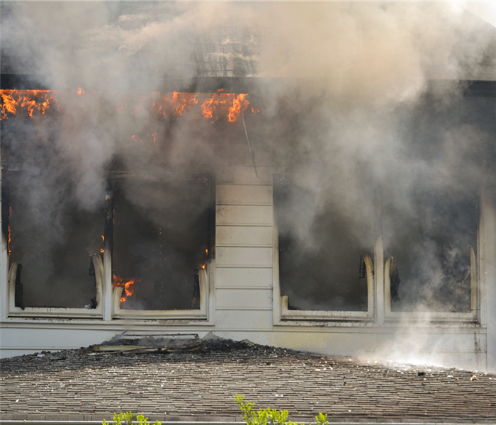 fire and smoke coming out of house window