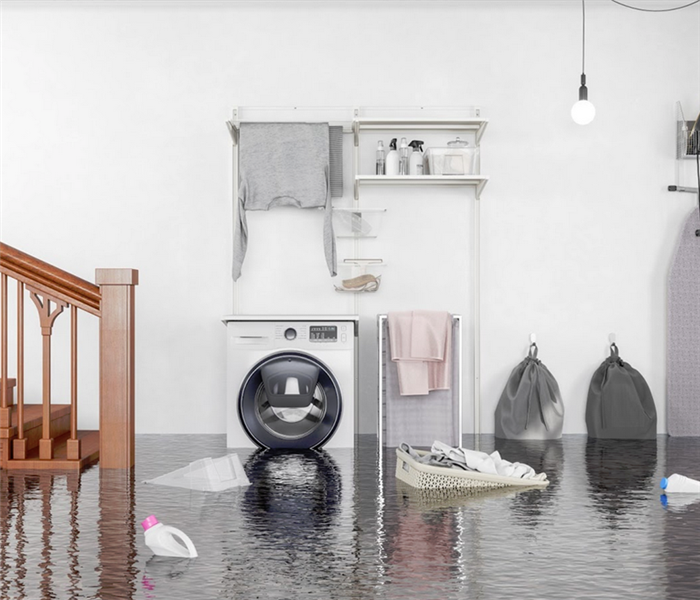 flooded basement of a house with a washer under about a foot of water