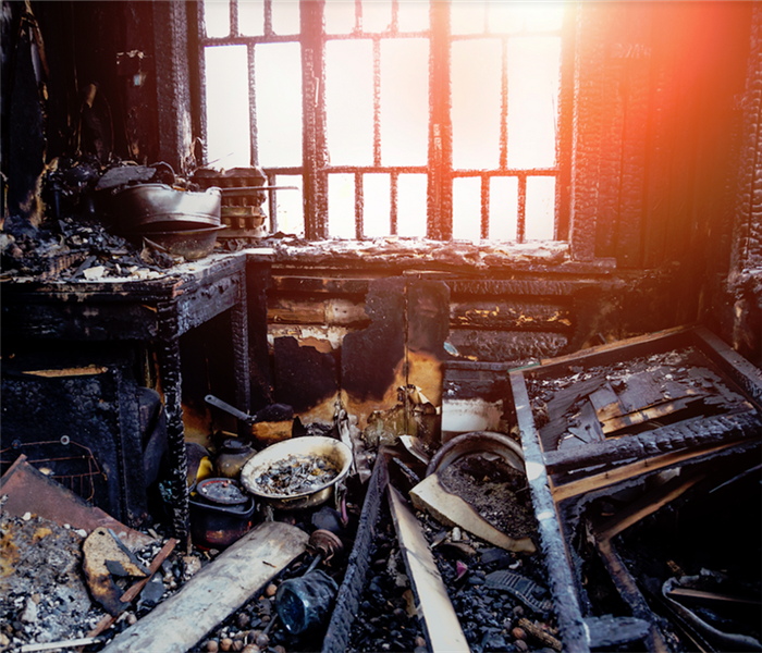 burned kitchen and remains of furniture in black soot